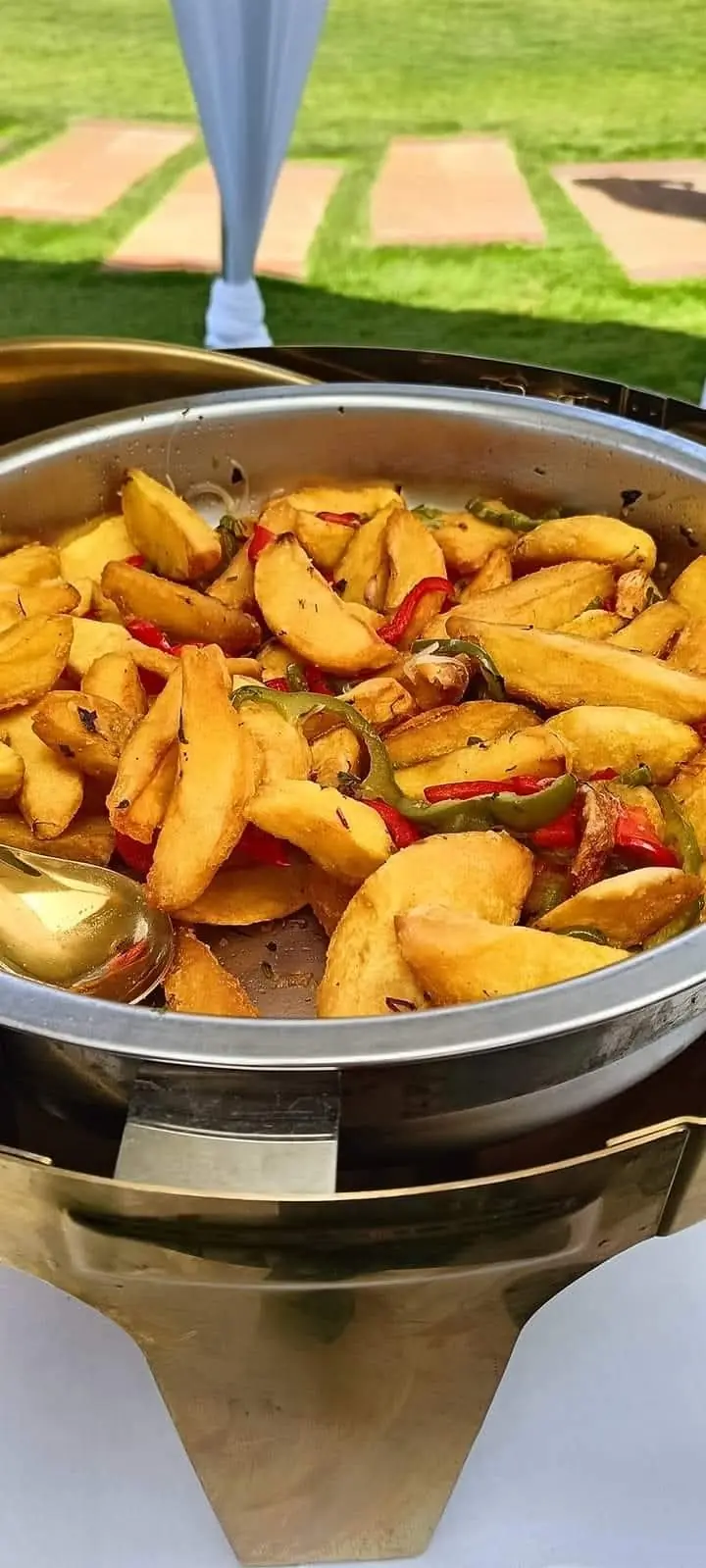 Potato wedges with red and green peppers in a warming dish on the lawn at Vipe Fun Park