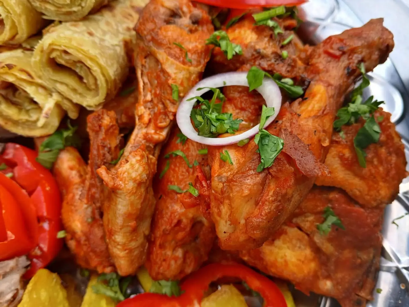 Chicken pieces in tomato sauce served with rolled chapati, peppers and fresh coriander at Vipe Fun Park