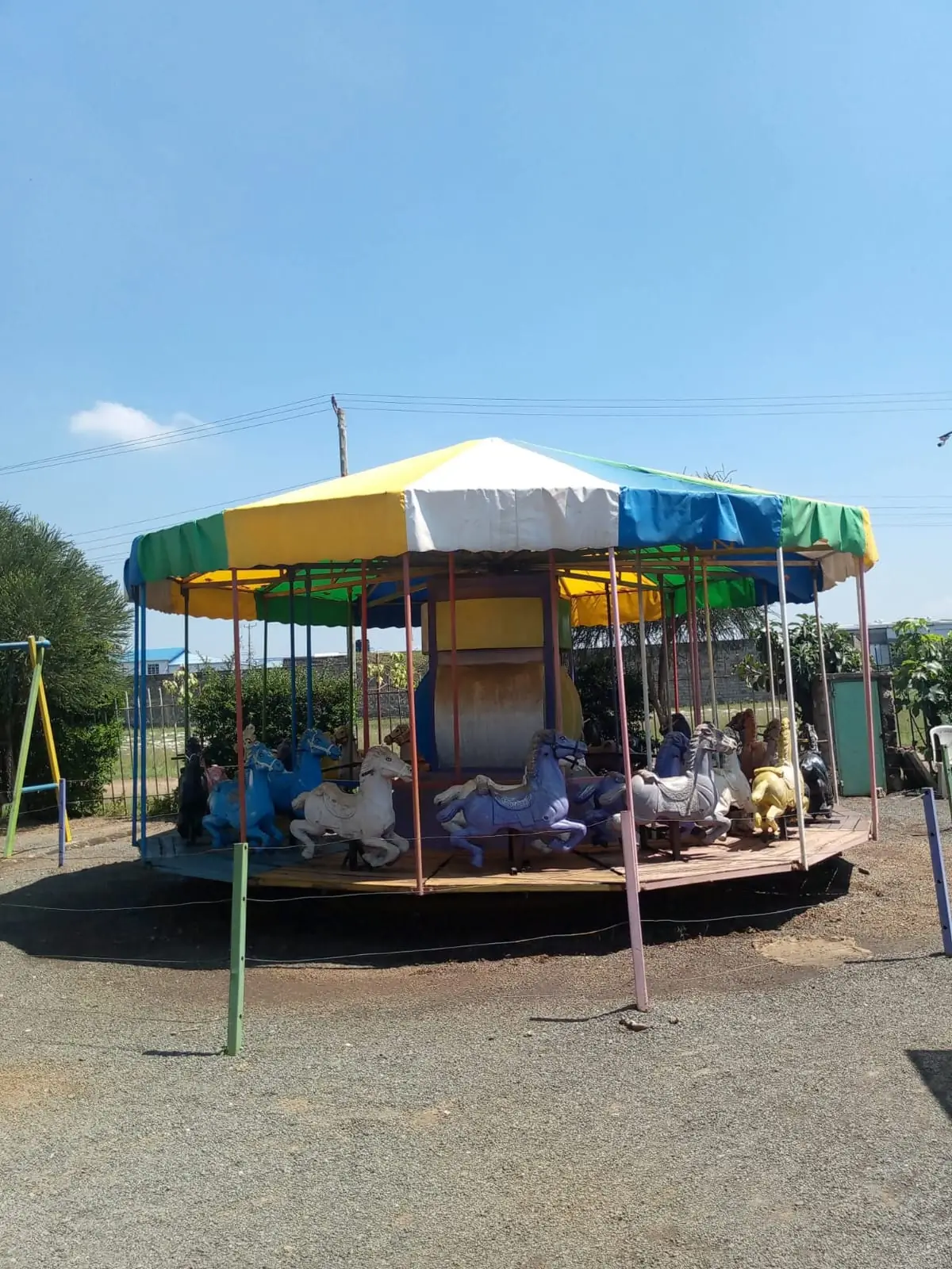 The colourful horse carousel at Vipe Fun Park under a clear blue sky
