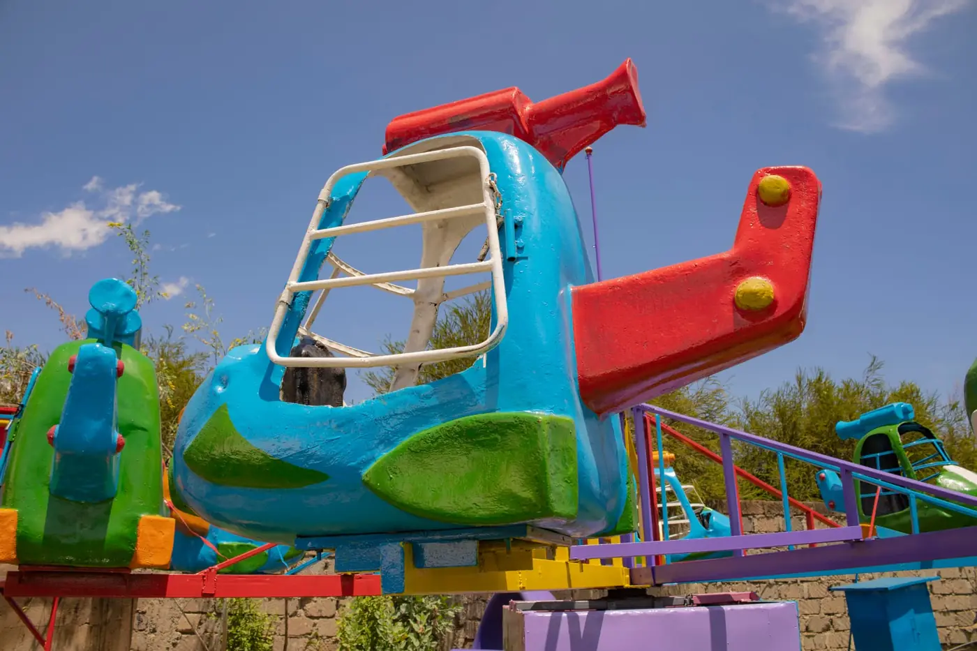 A children's helicopter ride painted blue, green and red at Vipe Fun Park