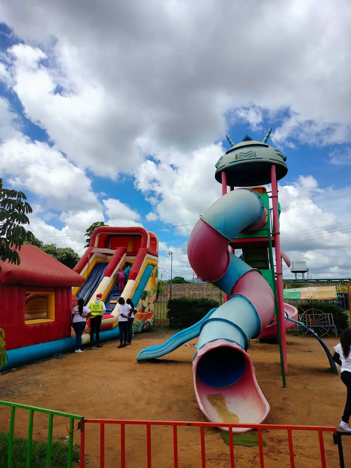 A large inflatable slide and bouncy house beside the playground tube slide at Vipe Fun Park