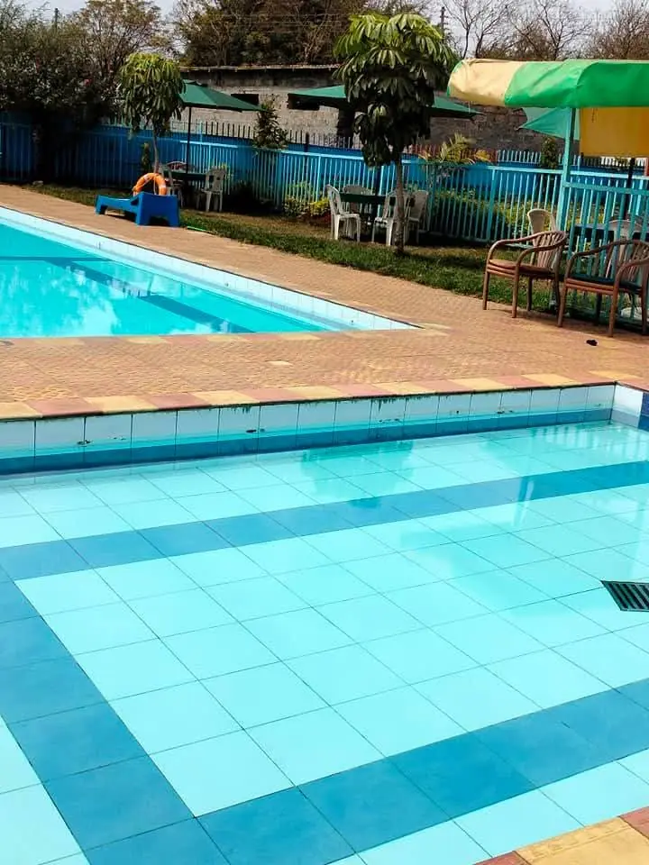 The poolside at Vipe Fun Park with seating, shade and clear blue water