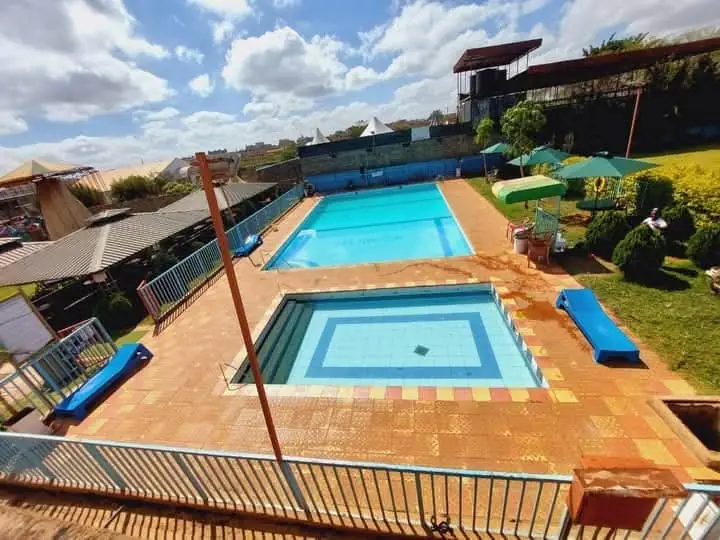 A raised view over the swimming pools and paved poolside at Vipe Fun Park
