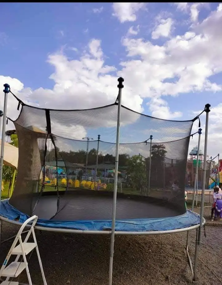 A round trampoline with safety netting set up at Vipe Fun Park